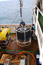 Launching CTD (conductivity, temperature, depth) water sampling equipment from deck of research boat GO Sars. Atlantic ocean deep sea research