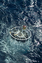 Launching CTD (conductivity, temperature, depth) water sampling equipment from research boat GO Sars. Atlantic ocean deep sea research