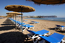 El Arenal, tourist beach with sun loungers and umbrellas, Javea, Spain.