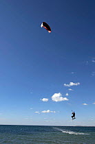 Kite surfer being lifted out of water, Playa de Gola, Santa pola, Alicante, Spain.