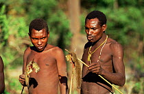 Hadzabe bushmen holding poison arrows with hunted ground squirrels, Lake Eyasi, Tanzania.