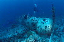 Diver at the wreck of a WW II Japanese fighter plane 'Nakajima Kate', Kavieng, Papua New Guinea