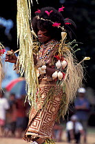 Female dancer at Sing-Sing celebration with tapa cloth skirt shell jewellery. Tufi, Oro Province, Papua New Guinea