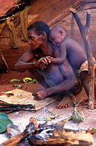 Ba'Aka pygmy mother and child, Ca,eroon, West Africa. The invasion of traditional forest refuges by logging companies and commercial bushmeat hunters jeopardises the lives of traditional forest-dwelle...
