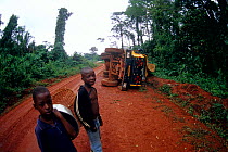Overturned logging truck on wet road, Central Africa.