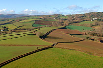 Aerial view of patchwork of  fields, woodland, hedges and lanes, Devon, UK. Winter