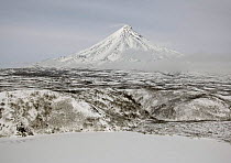 Kronotsky Volcano with frozen edge of Kronotskoye Lake in foreground, Kronotsky Zapovednik reserve, Russia.
