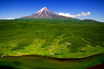 Aerial view of Park Ranger stations on the Kronotskaya River with volcano in background, Kronotsky Zapovednik Reserve, Kamchatka, Russia.