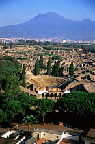 Roman amphitheatre and ruined city of Pompeii with Mount Vesuvius in the background, Southern Italy.