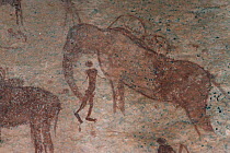 Rock art / cave paintings of people hunting elephant, Namibia.