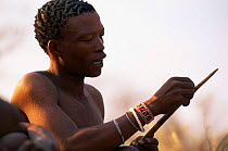 Jo / Hoan bushman with traditional arrow, Bushmanland, Namibia. 1996