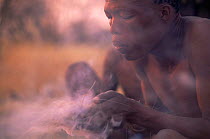 Jo / Hoan bushman making fire by traditional method, Bushmanland, Namibia. 1996