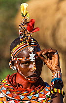 Samburu girl with bead hair pieces and necklaces, Laikipia, Kenya
