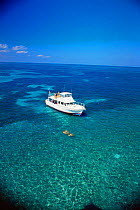 Pleasure boat and snorkelers, Molasses Reef, Key Largo National Marine Sanctuary, Florida, USA