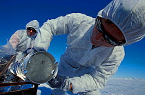 Researchers collecting ice core on ice floe. Overalls prevent contamination of the ice. (ISPOL (ICE Station Polarstern) Expedition 2004/2005 from Alfred Wegener Institute, Bremerhaven, Germany. The Ic...
