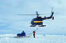 Helicopter transporting "CTD" (instrument for collecting water samples from all water depths) to research site 50 km away from the ice floe base. ISPOL (ICE Station Polarstern) Expedition 2004/2005 fr...