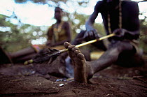 Hadzabe tribesman fashioning arrow at camp, Lake Eyasi Basin, Tanzania 2006