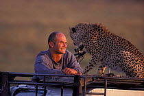 Simon King with Amber's male cheetah (Acinonyx jubatus) cub. BIG CAT DIARY