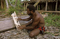 Asmat man carving statue, Western Papuasia, Indonesia (Formerly Irian Jaya) 2002 (West Papua).