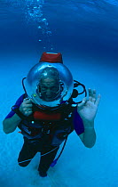 Sir David Attenborough in bubble helmet underwater during filming of BBC television series Trials of Life, 1989 North Bahama Banks