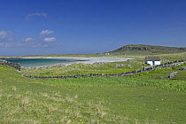 Old kelper's cottage, beach and priory in distance, Isle of Oronsay, Scotland UK. June 2006