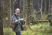 Dave Anderson, Forestry Commission conservation officer, radio-tracking pine martens to establish predation impact on red squirrels and tawny owls, Trossachs Forests District, Scotland. 2006