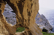 View through eroded hole in rock, Pomègues isle, Frioul archipelago, Marseille, France