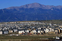 Rapid housing growth expanding in Colorado Springs with Pikes peak in background. 2004.