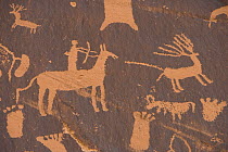 Rock art, close-up of Man on Horse hunting Deer, Newspaper Rock National State Monument petroglyph Montecello, Utah.