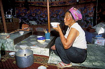 Woman drinking in Ger /Yurt, Gobi Desert, Mongolia