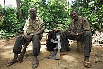 Members of the Wildlife Conservation Society anti-poaching patrol team relaxing with their AK47 and rifle guns beside them, Dzanga-Sanga Bai, Bayanga, Central African Republic, 2003