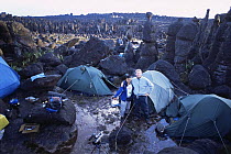 Camping on Kukenon, flat top tepuis, southern Venezuela, South America.  Mark Brownlow and guide on location for BBC Planet Earth series. November 2005