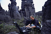 Richard Kirby, camerman on location with timelapse equipment for BBC Planet Earth series, Kukenon, flat top tepuis, southern Venezuela, South America. November 2005