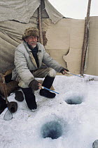 Local man showing the traditional winter way to fish for food through hole in ice in Lake Baikal, world's deepest and oldest (and largest by volume) freshwater lake, Siberia, Russia. BBC Planet Earth...