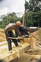 Workers sieving the sludge to get separate the gold, Suriname . 2003.