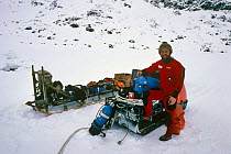 Doug Allan, cameraman, on skidoo with underwater camera gear on location for BBC 'Life in the Freezer', Antarctica, 1995