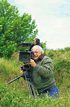 Camerman Martin Saunders with Takahe (Phorphyrio hochstetteri) on his head while filming for BBC 'Life of Birds', New Zealand, 1997