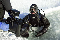 Doug Allan about to film under the ice, on location for BBC Planet Earth, Iceworlds programme, March 2006. Belcher Islands, near Sanikiluaq, Hudson Bay, Canada. Temperature was around -20C.