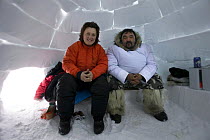 Sue Flood with local Inuit guide, Simeonie, inside an ice igloo in Belcher Islands near Sanikiluaq, Hudson Bay on location for BBC Planet Earth Iceworlds programme. 2006