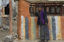 Old lady at prayermill, Chorten of Geling, Mustang, Nepal