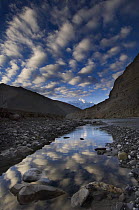 Reflection of clouds in water next to the Kali Ghandaki river, Nilgiri range, Chhusang, Lower Mustang, Nepal