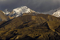 Arid mountains crowned by snow-caapped peaks, viewed from Syangboche, Lower Mustang, Nepal. November 2004
