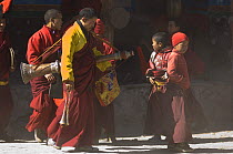 Napalese monks, carrying 'Lawa' (long trumpet)preparing for the final ceremony of 'Duk chu' festival, where monk's dance and prayer for a prosperous year. Lo-Manthang, Upper Mustang, Nepal.