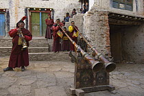 Monks playing 'Lawa' (long trumpet) Lo-Manthang at the end of the 'Duk chu' festival, Upper Mustang, Nepal