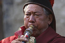 Portrait of Nepalese monk playing 'Geling' (short trumpet) Lo-Manthang, Upper Mustang, Nepal.