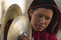 Nepalese monk playing 'Cignil' or cymbals during 'Duk chu' festival, Lo-Manthang, Upper Mustang, Nepal