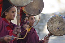 Nepalese monks, playing 'Nha' or hand-drum during 'Duk chu' festival, Lo-Manthang, Upper Mustang, Nepal