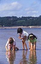 Young children playing on beach, UK