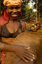 Woman panning for gold and showing a gold nugget. This mining is now illegal as it takes place in the protected forest of Daraina which is the habitat for the Golden-crowned / Tattersall's sifaka (Pro...