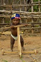Young child learning to use a home-made walker, Daraina, northern Madagascar 2005